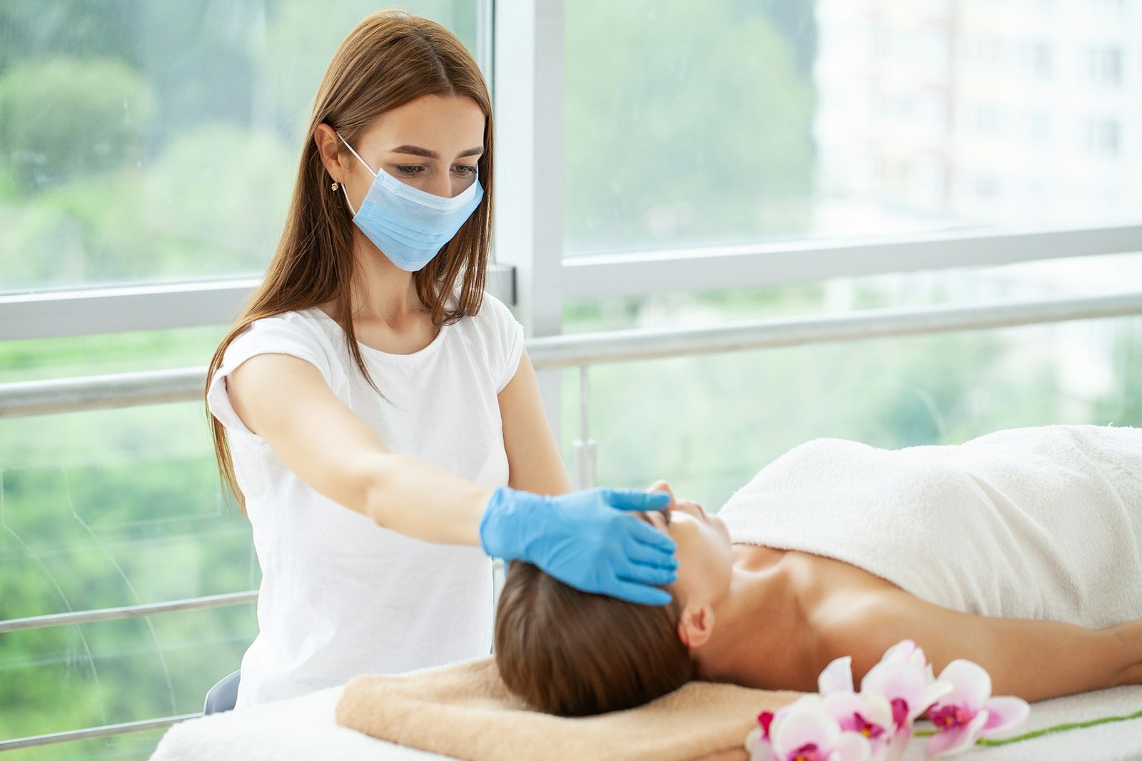 Beautiful girl has a facial massage in a beauty clinic.